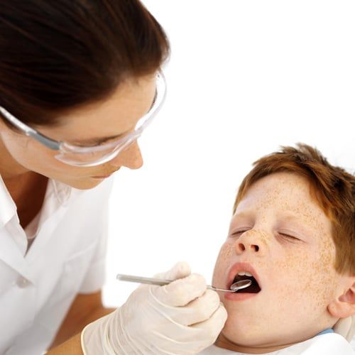 Dentist looking in child's mouth